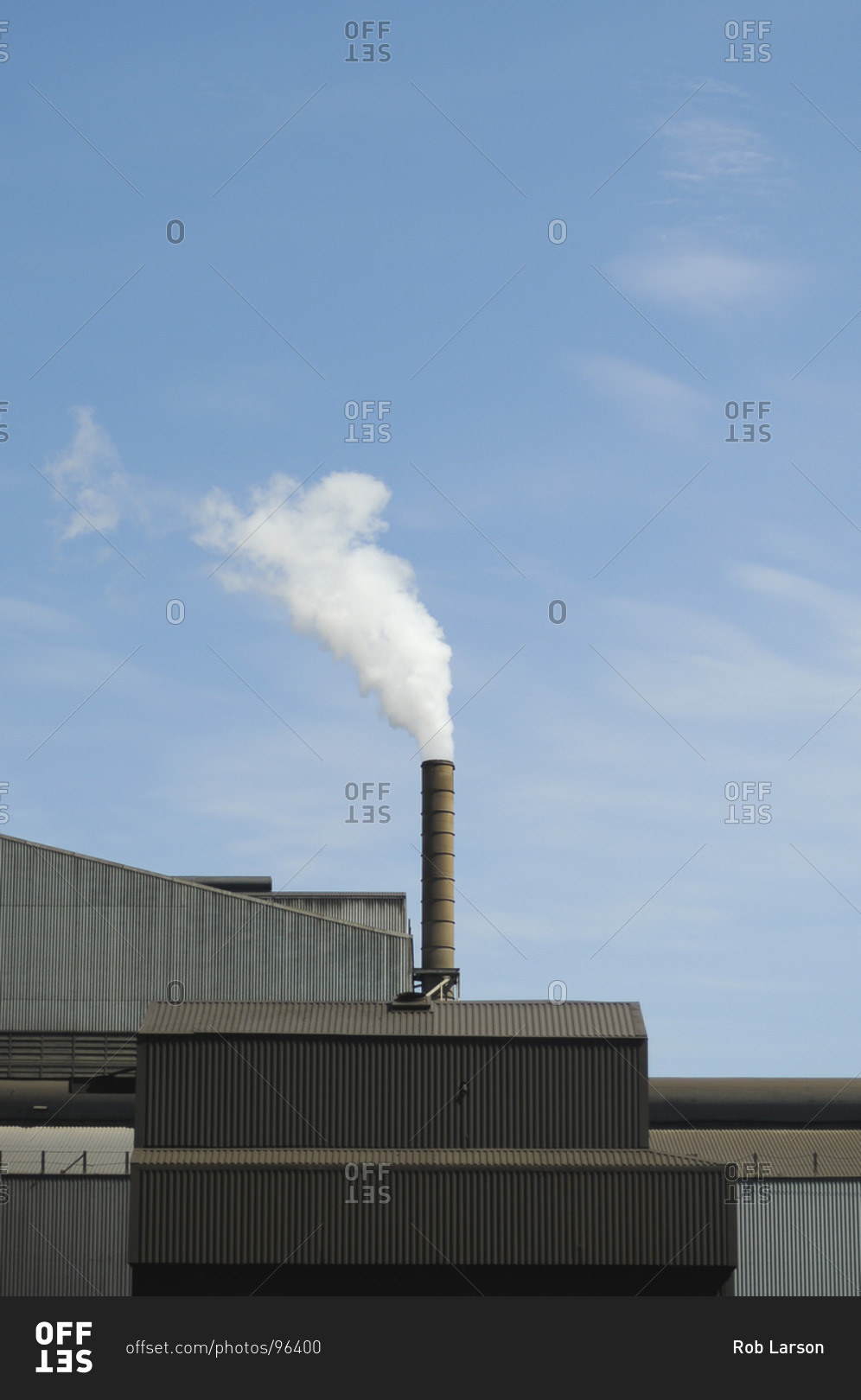White smoke coming out of an industrial chimney