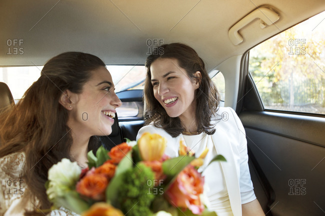 Newlyweds lesbian couple sitting in car