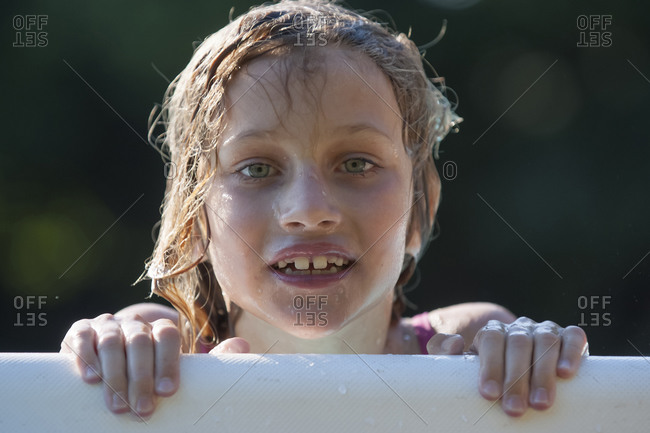 Italy, Tuscany, Wet girl in swimming pool