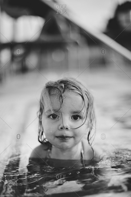 Portrait of a girl sitting in a pool