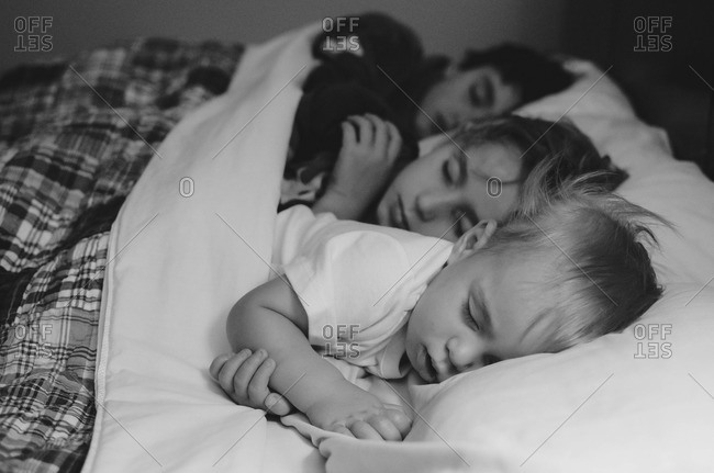 Brothers sleeping together in double bed