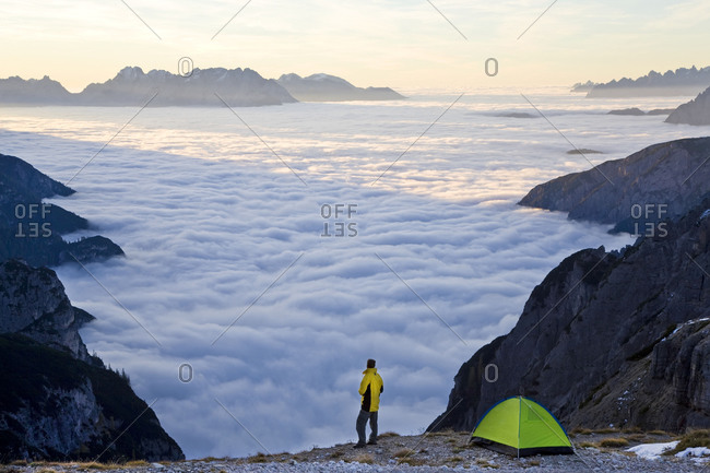 Man camping above the clouds at the Dolomites