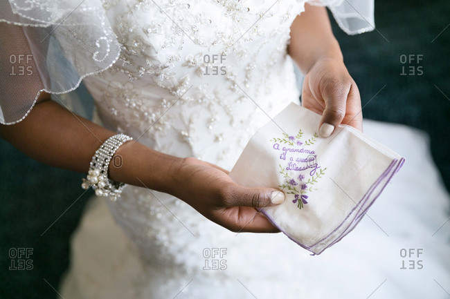Bride holding embroidered wedding handkerchief