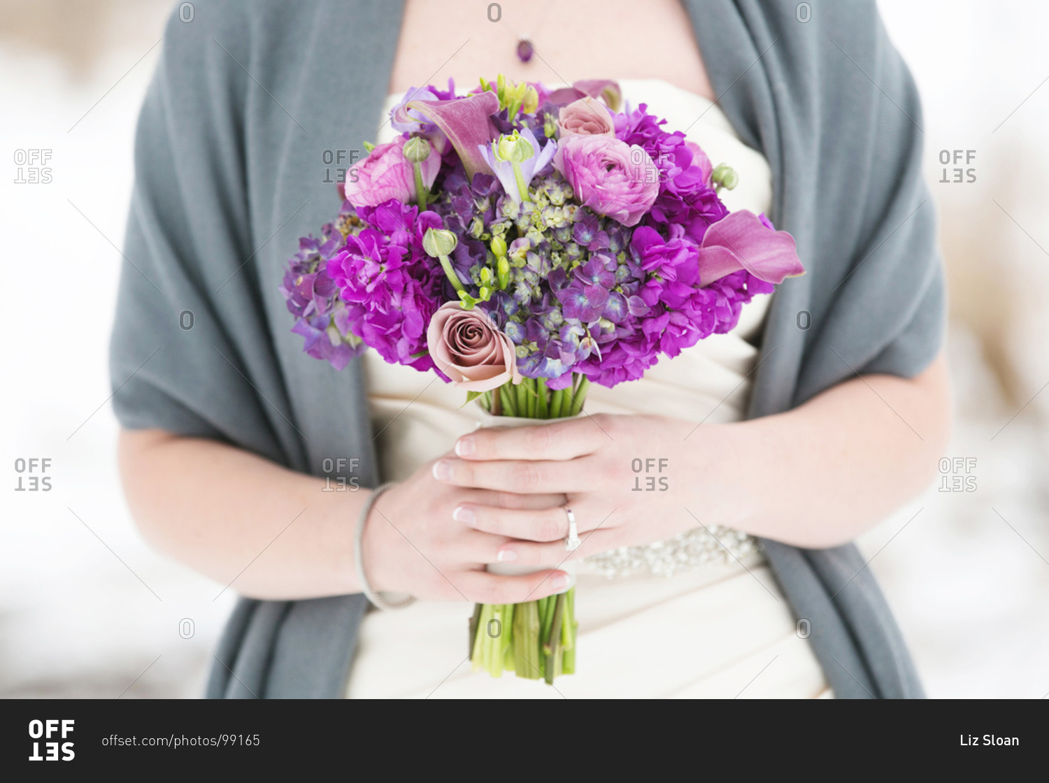 Bride holding purple wedding bouquet