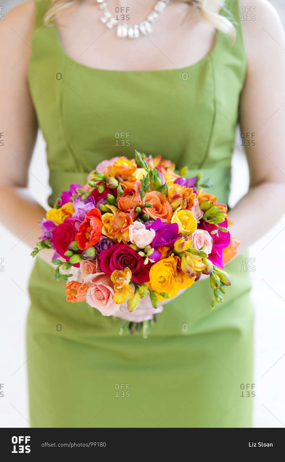 Bridesmaid holding colorful wedding bouquet