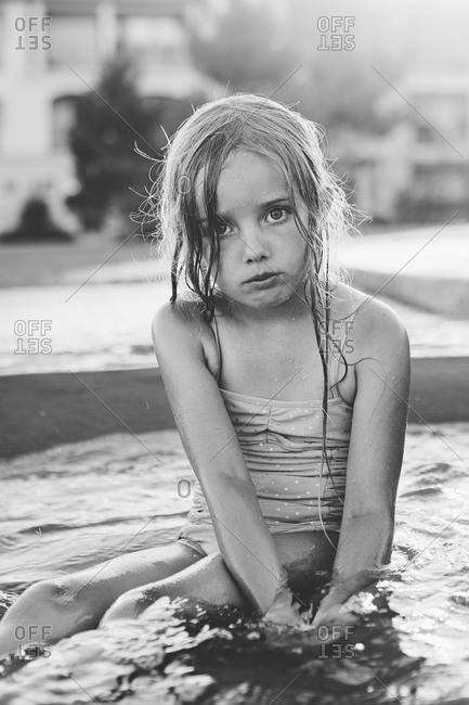 Sad girl sitting in pool
