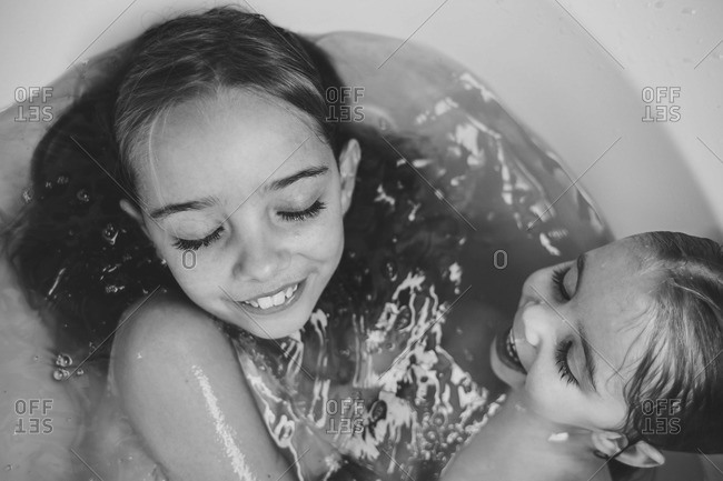 Black and white image of sisters sharing a bath