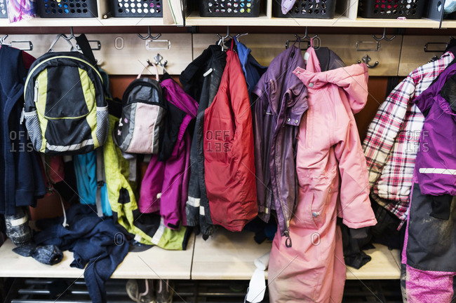 Winter coats and backpacks in wardrobe at kindergarten