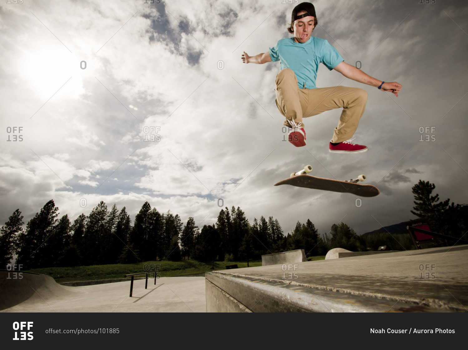A skater kickflips his skateboard on a cloudy day at the skatepark in Whitefish, Montana.