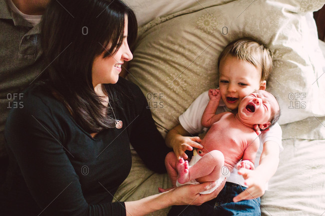 Mother Comforting Her Baby On A Bed Stock Photo Offset