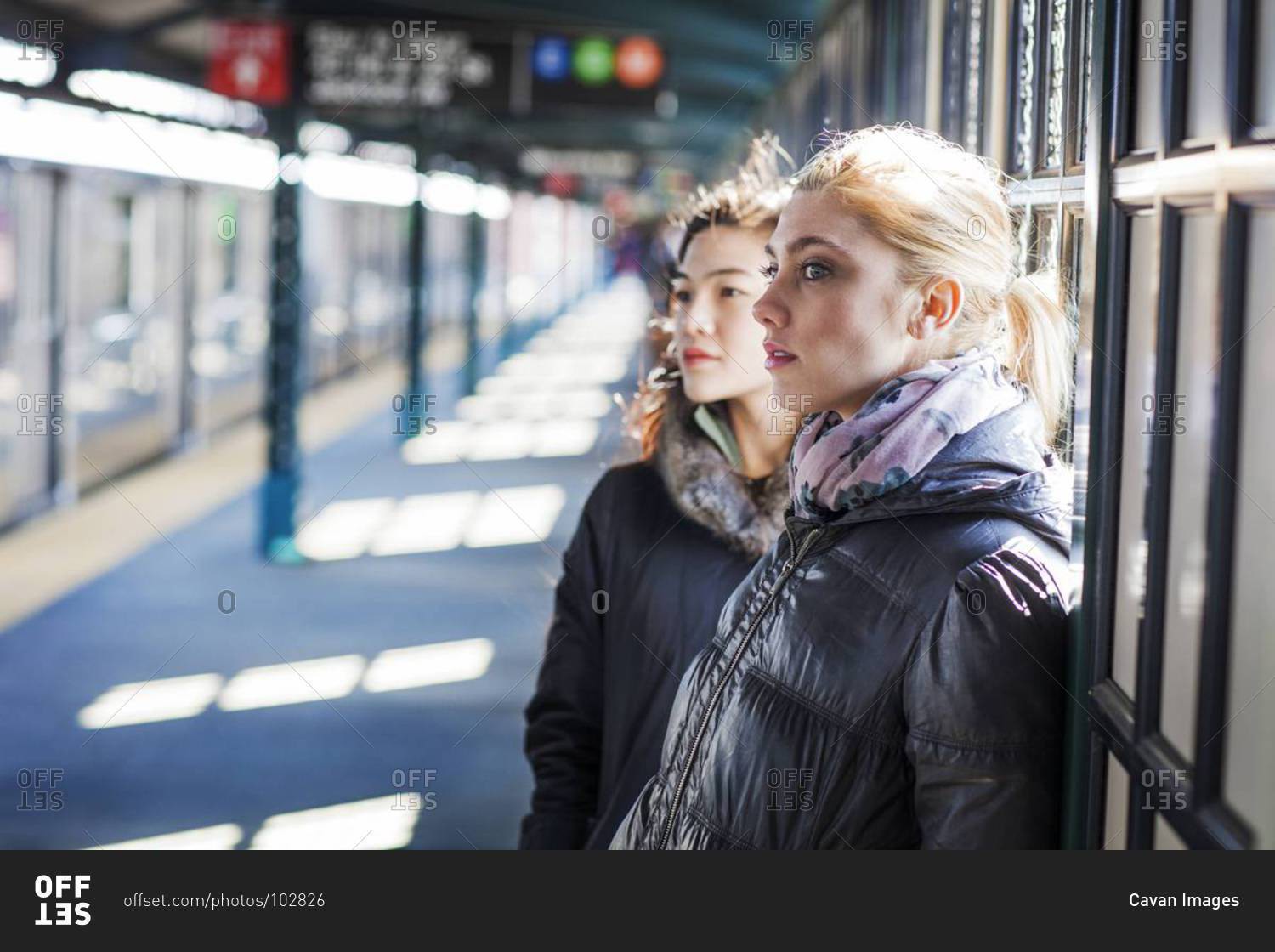 Young women waiting for a train at a station