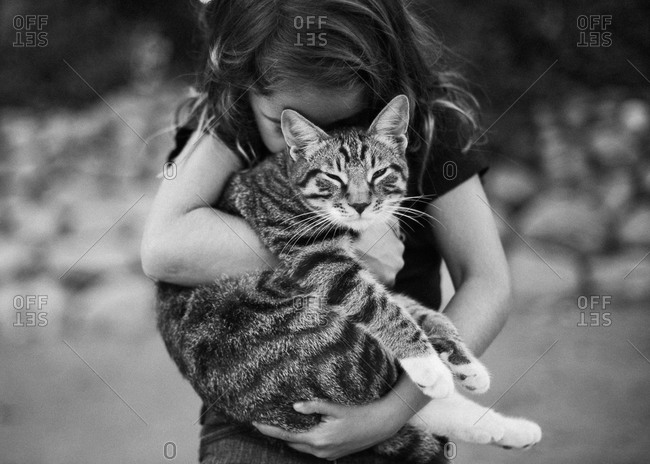 Girl hugging a cat