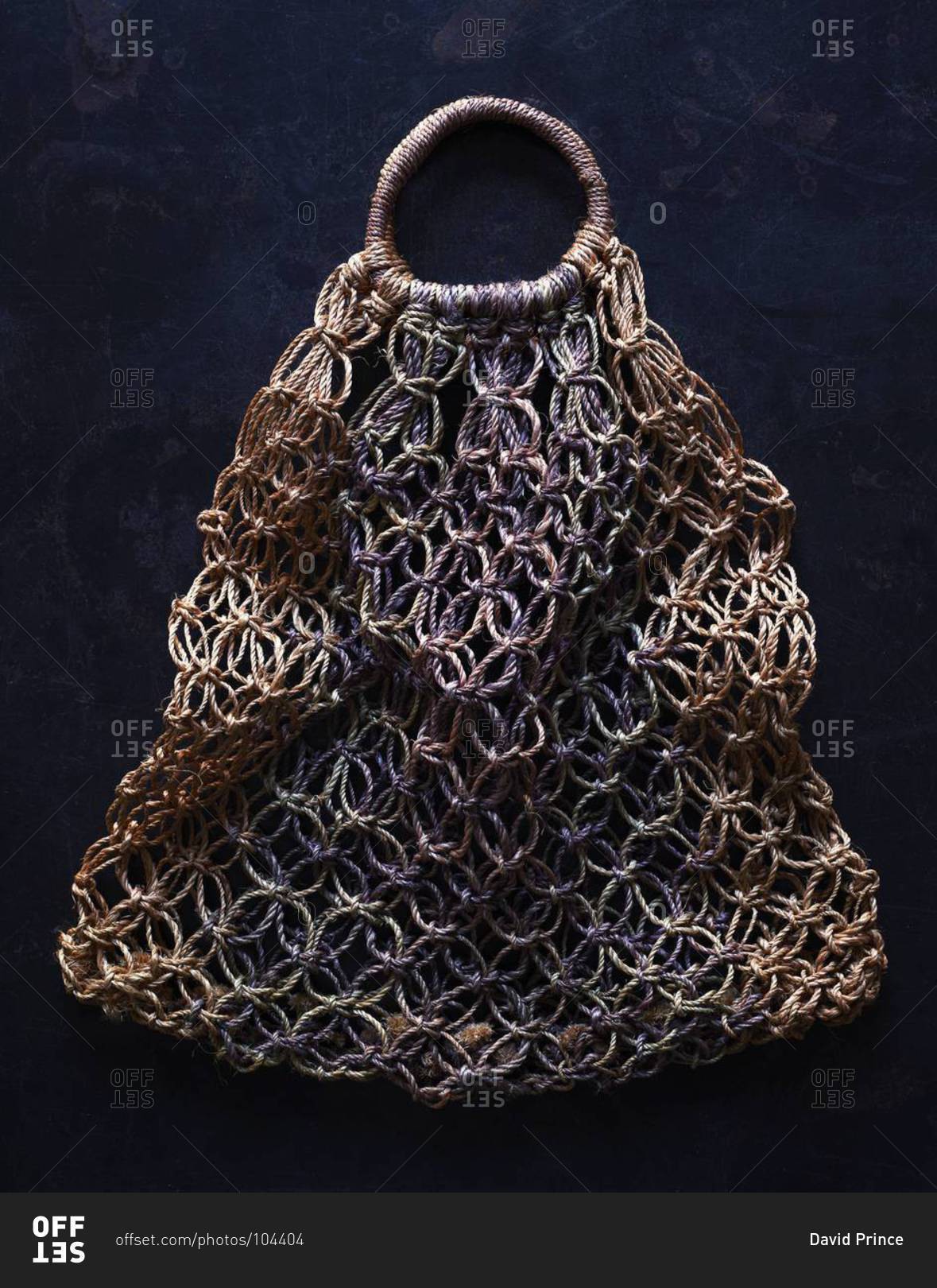 Woven bag on black background stock photo - OFFSET