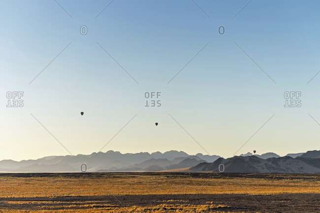 Three hot air balloons floating over the desert, Sossusvlei, Namibia, Africa