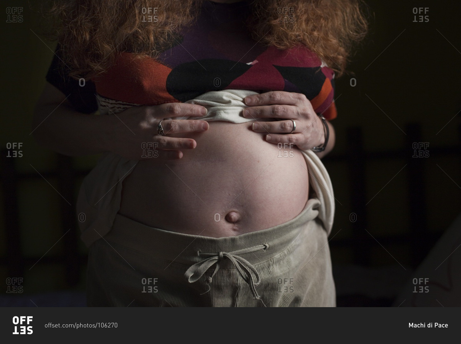 Artificially inseminated pregnant woman showing her abdomen