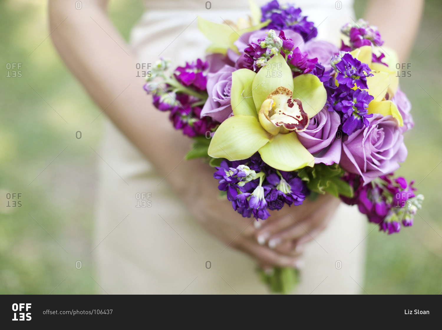 Mid section view of bride holding purple and green bridal bouquet
