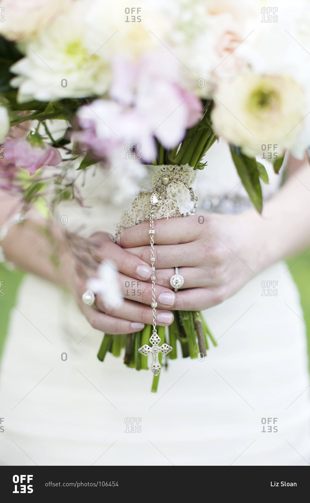 Mid section view of bride holding pale bridal bouquet