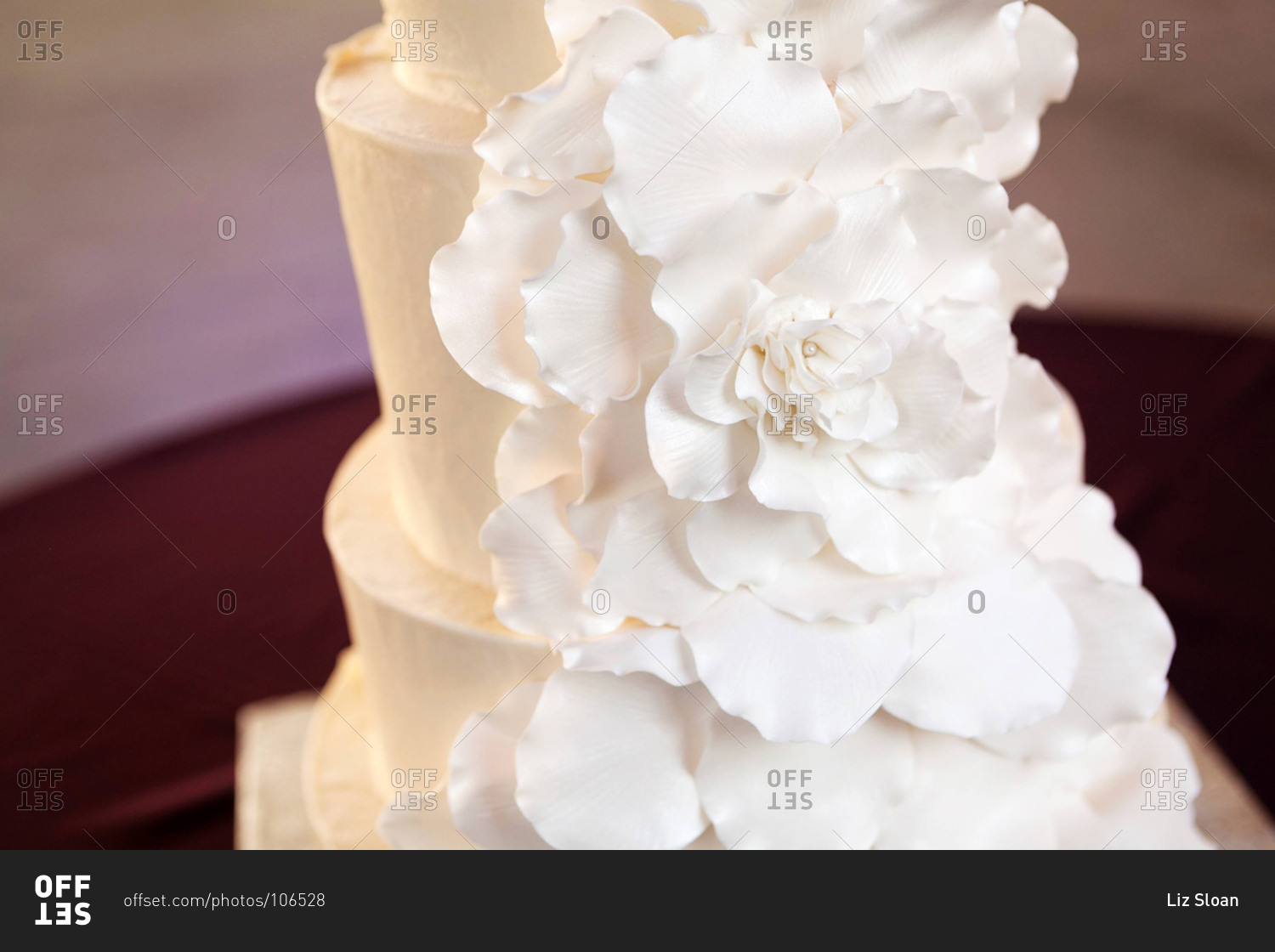 White cascade of rose petals on a wedding cake