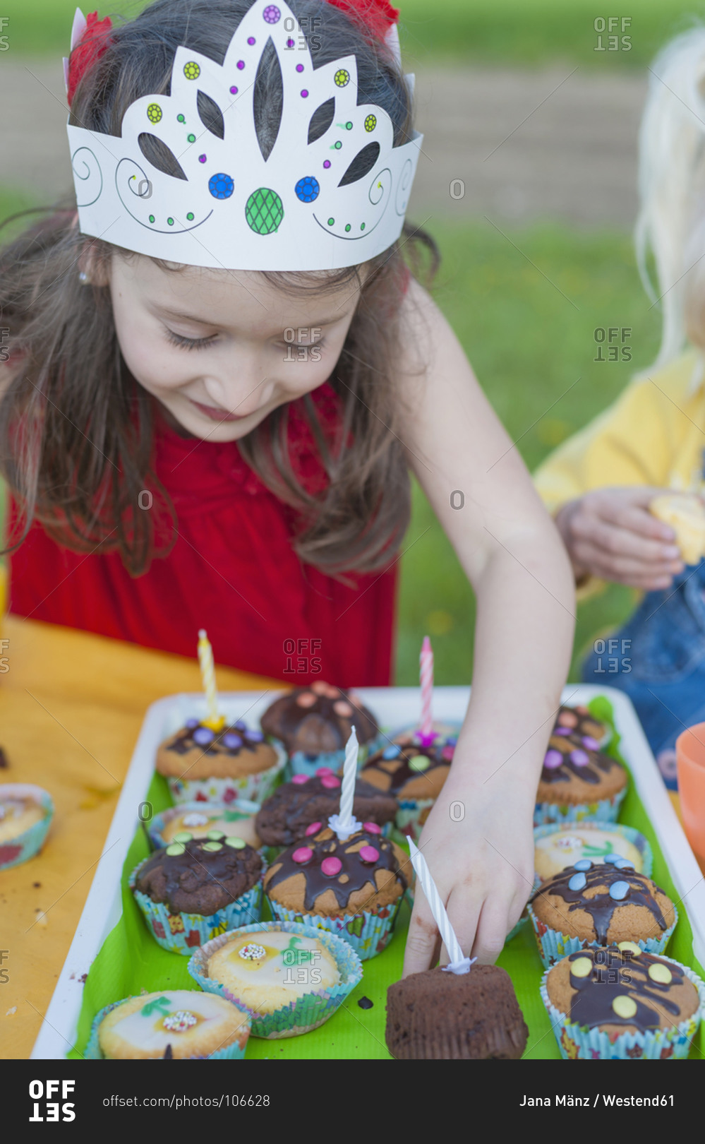Little girl with birthday muffins