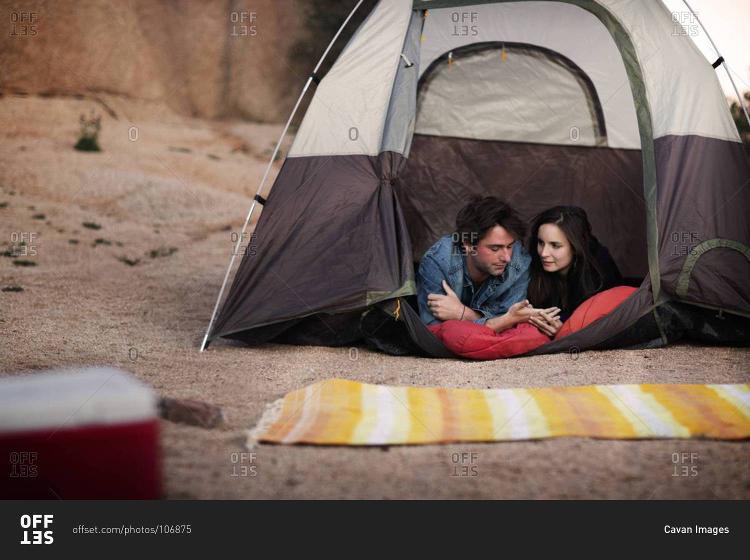 Camping couple lying in a tent