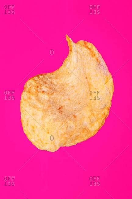 A single golden brown potato chip