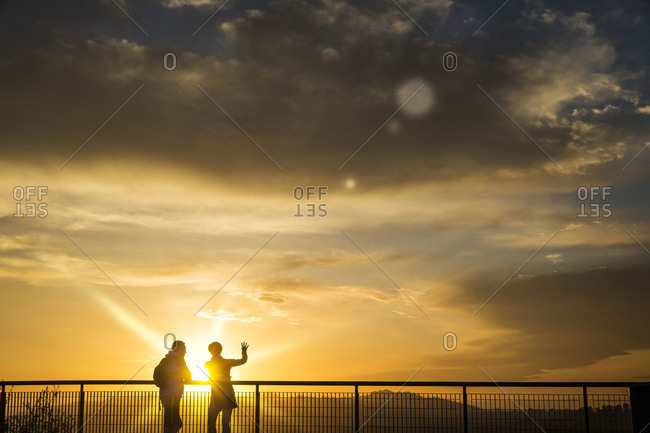 Silhouette of people at glaring sunset