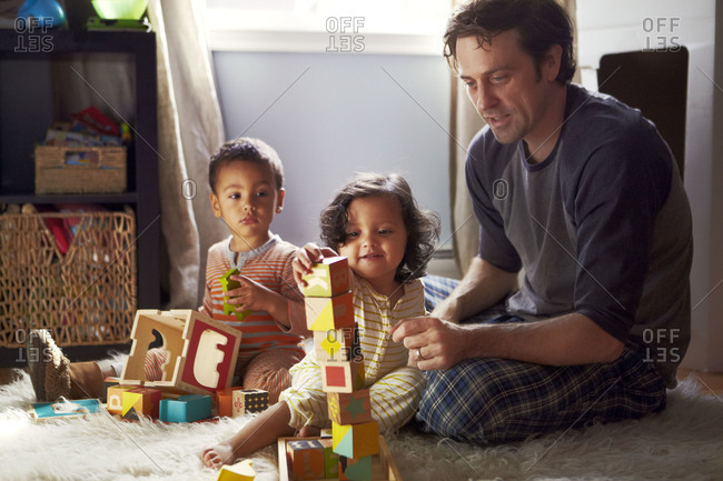 Father and kids playing with building blocks