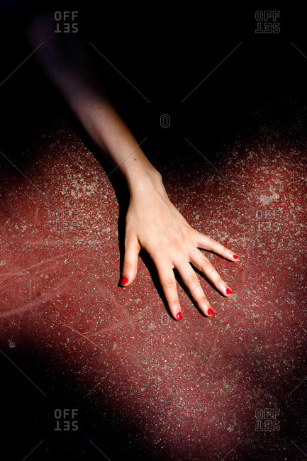 Studio shot of a woman's hand with painted fingernails