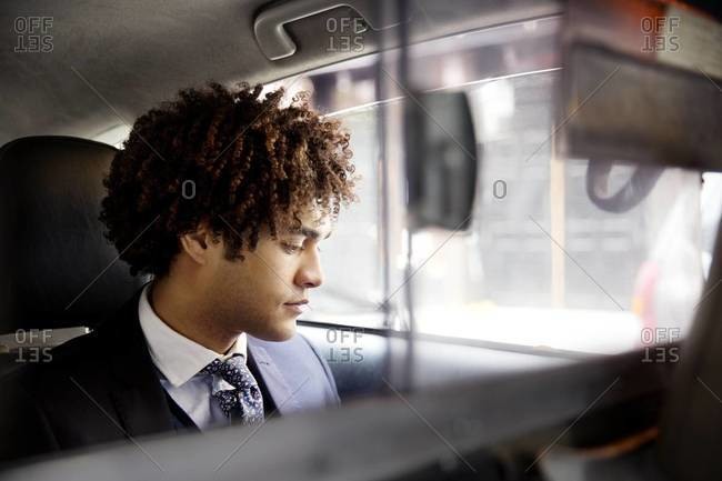 Pensive businessman in cab - Offset