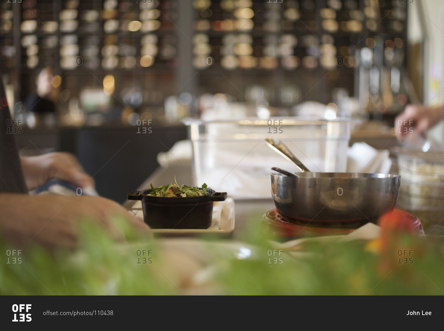 Person preparing food in a cast iron pot dish