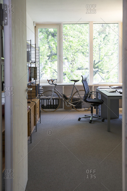 Racing cycle standing at workplace of modern office