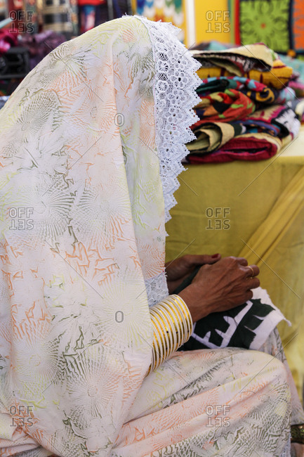 Pakistani woman embroidering rug - Offset