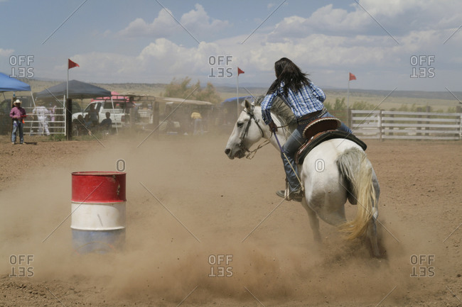Barrel racer cowgirl in Galisteo Rodeo, New Mexico, United States