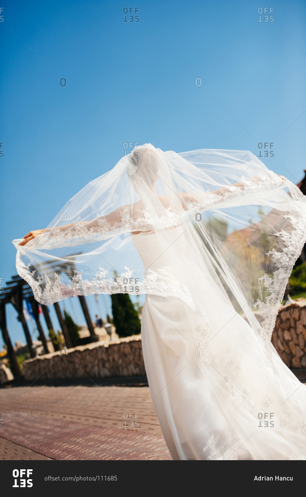 Bride enjoying the wind in her wedding dress