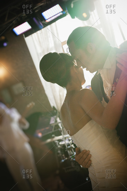 Newlyweds dancing close reception
