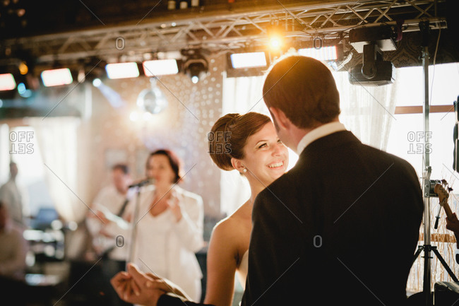 Newlywed dancing to live band at the reception