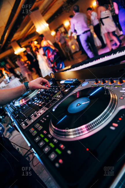 A disc jockey performing at a wedding reception