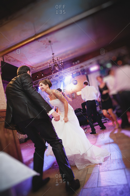 Newlywed couple busting a move at the reception
