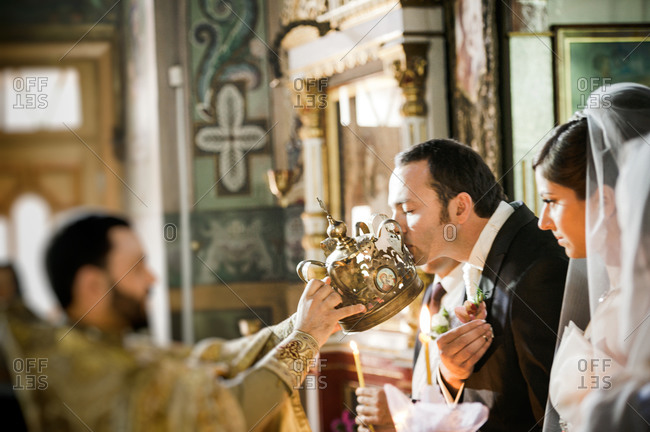 Groom kissing a crown at an Orthodox wedding