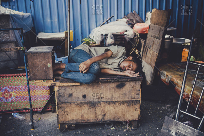 Phnom Penh, Cambodia - March, 2014: Homeless man taking a nap