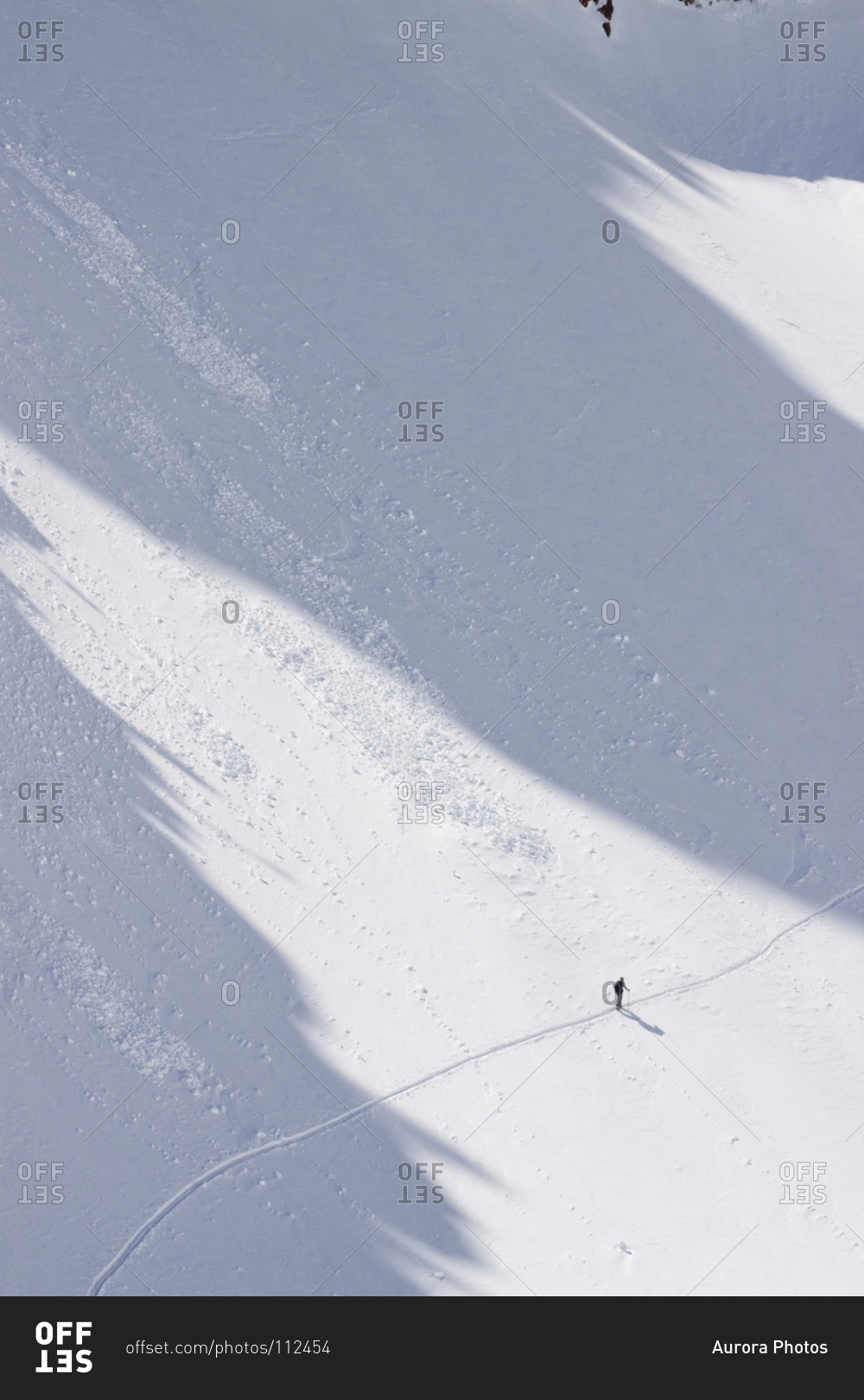 A backcountry skier under the Jesus Christ Couloir on Thompson Peak in the Sawtooth Mountains near Stanley, Idaho