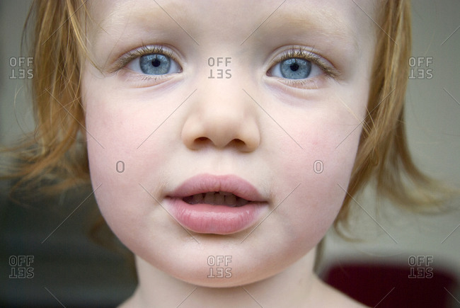 Portrait of red haired girl with blue eyes stock photo - OFFSET