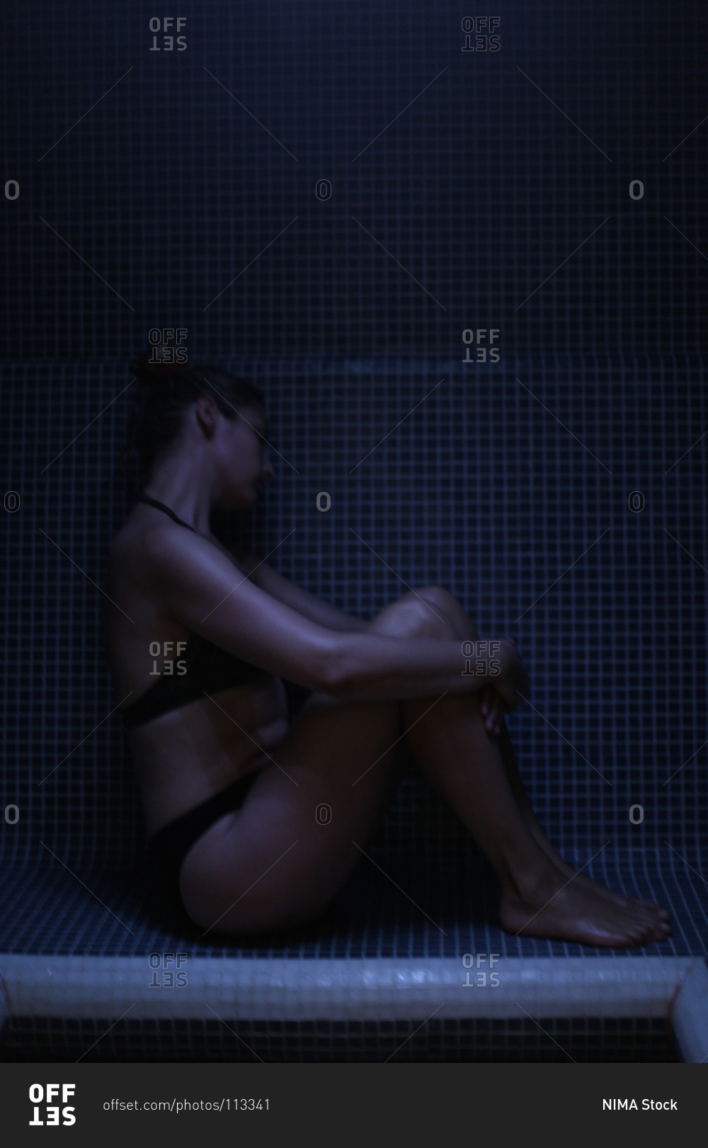 Woman relaxing at steam room of health spa