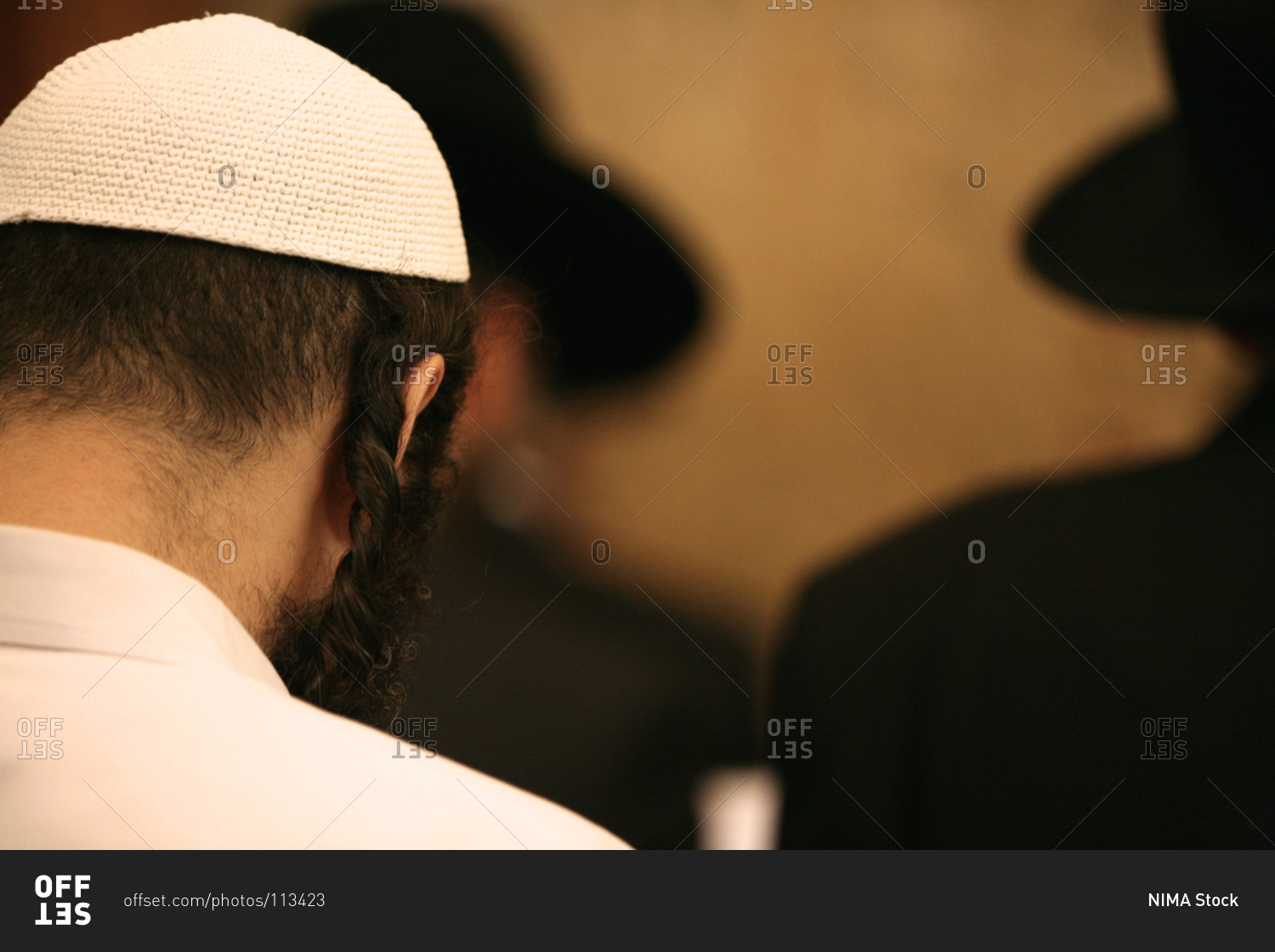 Rear view of a Jewish man with traditional hairstyle wearing a kippah