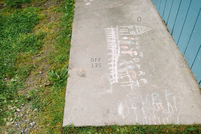 A child's chalk drawing on cement