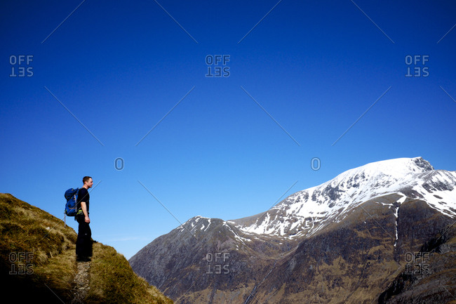 Man pausing during mountain hike