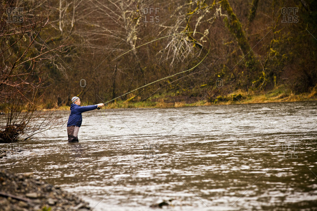 Man fly fishing in rural river