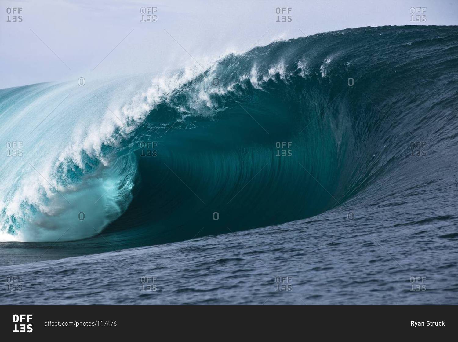 Massive ocean wave barrel in Tahiti stock photo - OFFSET