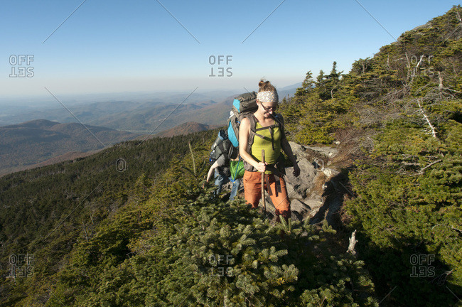 Vermont, USA - October 9, 2011: Woman hiking at Camel's Hump