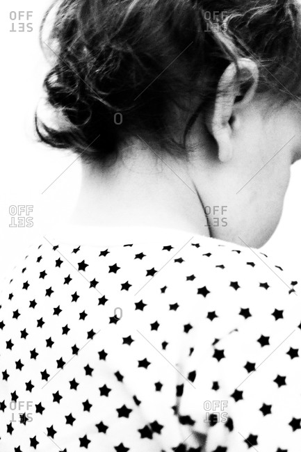Back view of a child wearing a patterned shirt